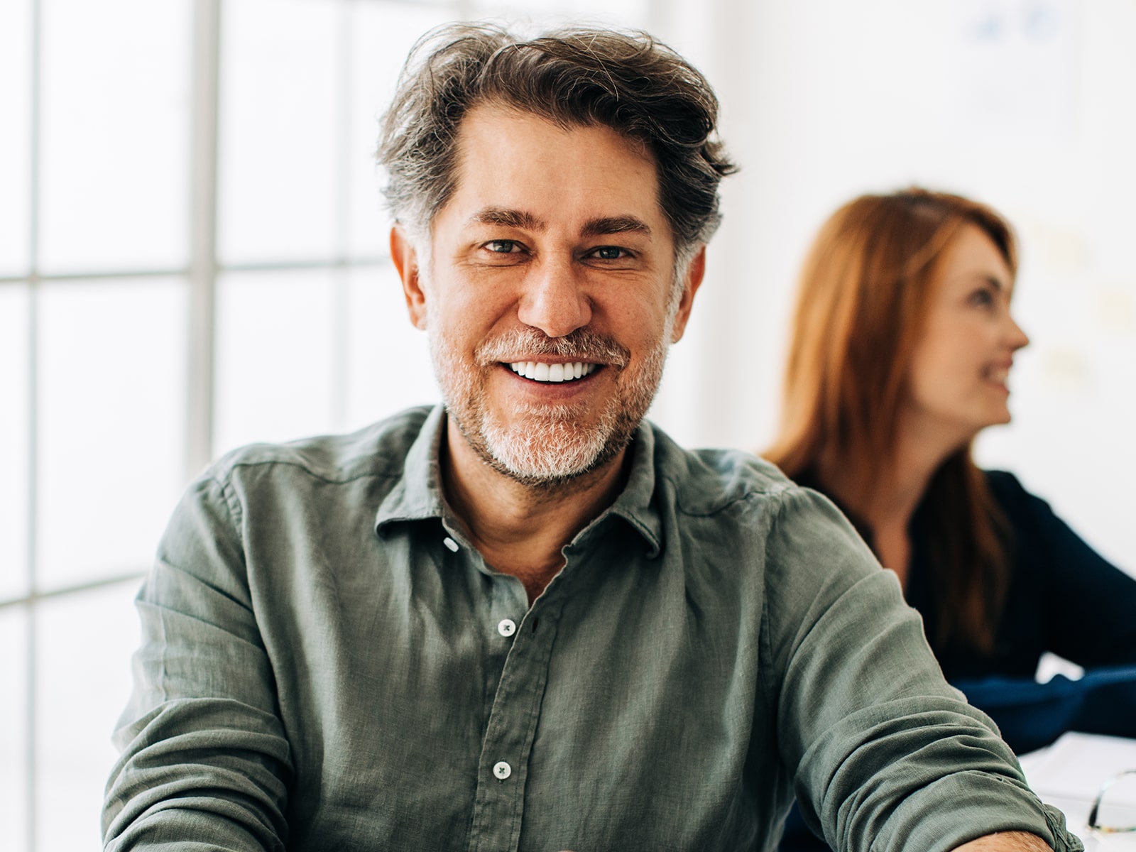 Office man smiling at desk-min Office man smiling at desk